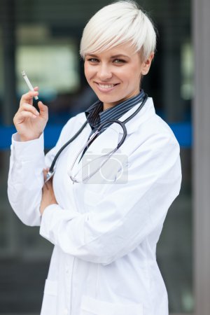Female doctor is smoking