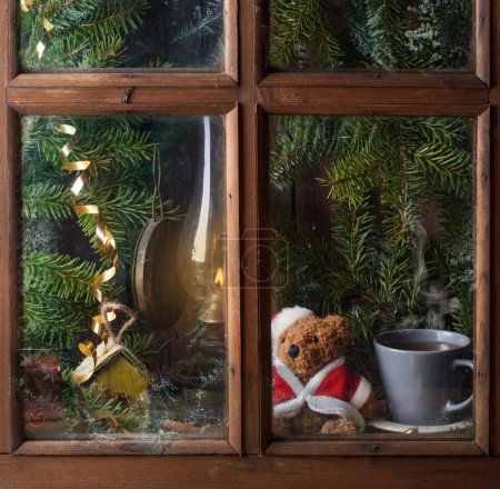Christmas decoration with teddy bear in window