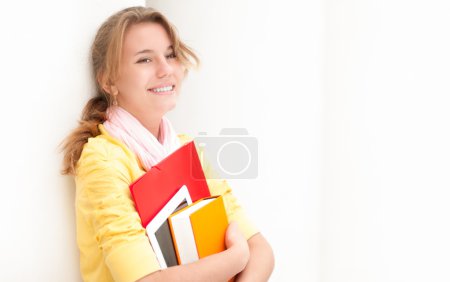 Young pretty female student on white background.