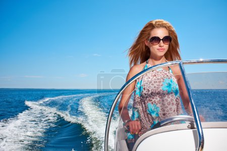 Young girl driving a motor boat