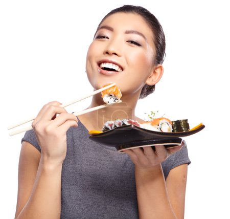 Woman holding sushi with chopsticks