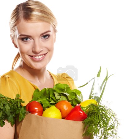 woman holding a shopping bag full of groceries, mango, salad, r