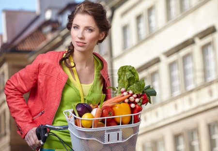 Woman with bicycle and groceries