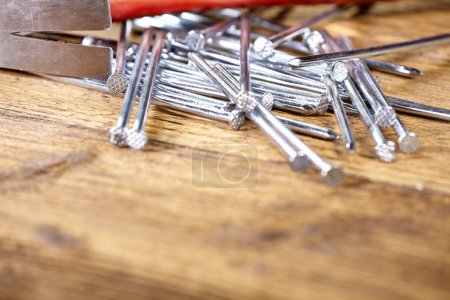 hammer and nails on old wood table