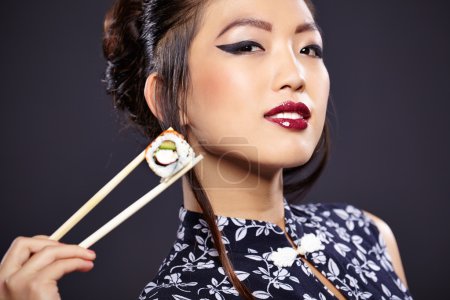 Asian woman eating sushi