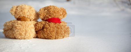 Teddy bears on a snow around each