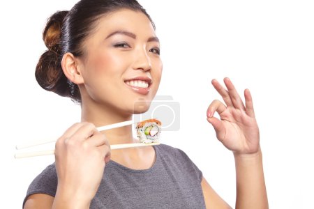 Woman holding sushi with a chopsticks