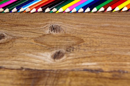 Set of color pencils on old wooden