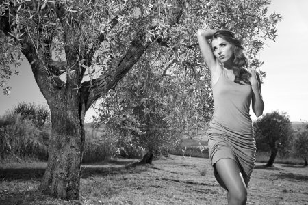 Woman among olive trees