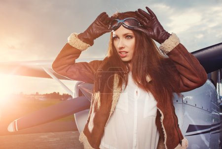 Woman pilot in front of airplane