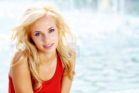 Closeup portrait of a beautiful woman in the city at summer time