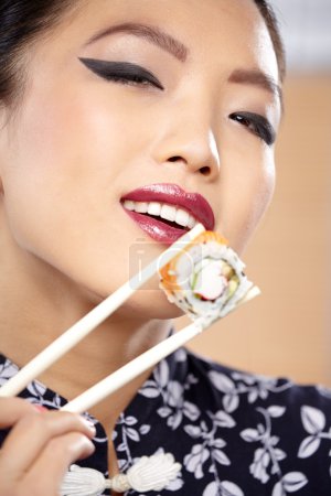 Woman showing a plate of sushi