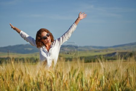 Woman in wheat field enjoying