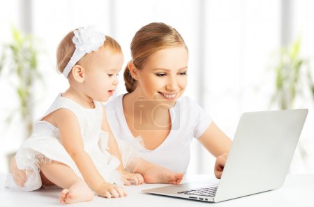 Mom and baby with computer working from home
