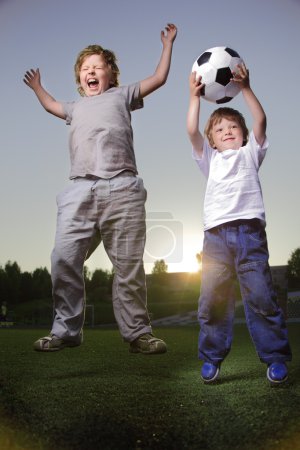 Two happy boy play in soccer