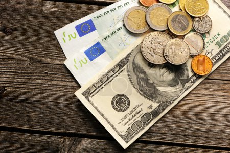 US and euro money over wooden background