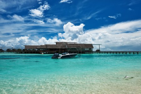 Beautiful island beach with motor boat 