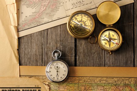 Antique compasses over old map