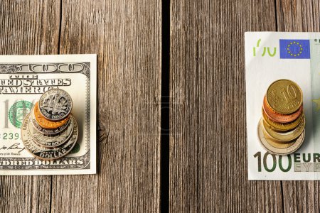 US and euro money over wooden background