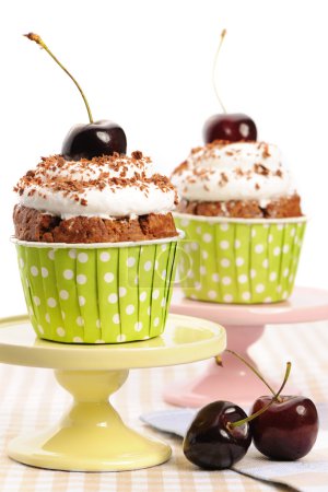 Cupcakes with whipped cream and cherry