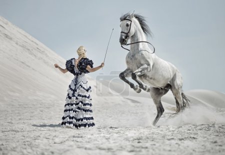 Attractive blonde training the horse