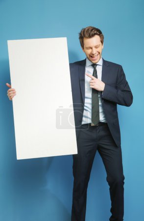 Joyful businessman carrying the white board