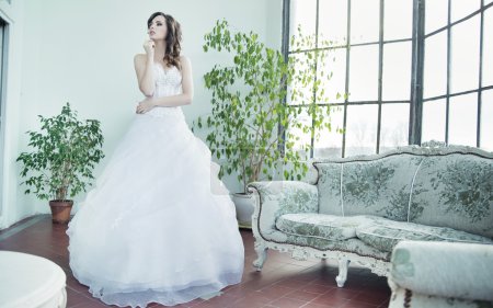 Attractive brunette bride thinking about future