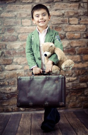 Stylish boy with suitcase