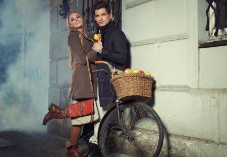Young couple with wicker basket full of apples