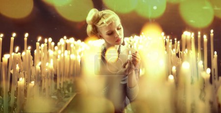 Adorable woman among milions of candles