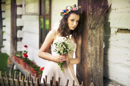 Young woman with buquet of wild flowers