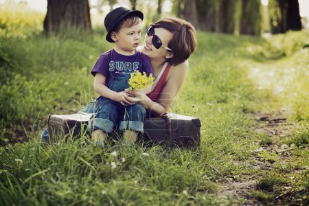 Nice picture of mother and son on the meadow