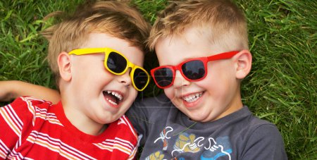 Smiling brothers wearing fancy sunglasses