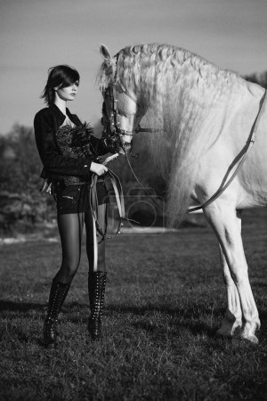 Black&white phoyo of redhead lady with horse