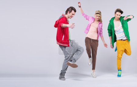 Cheerful young friends dancing together