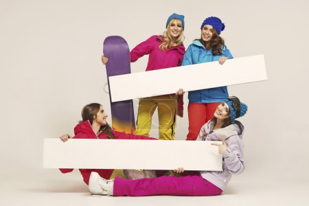 Group of the cheerful female snowboarders