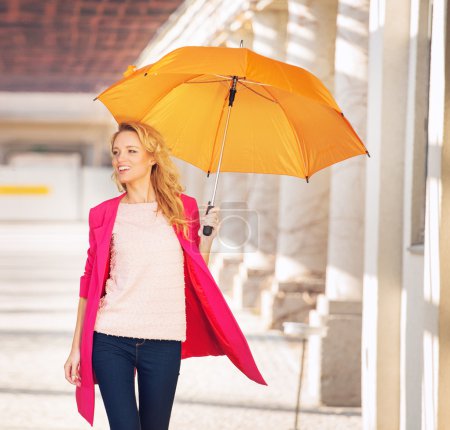 Smiling smart woman with the umbrella