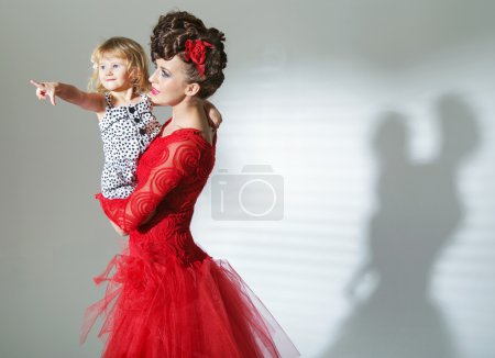 Elegant brunette lady with cheerful child