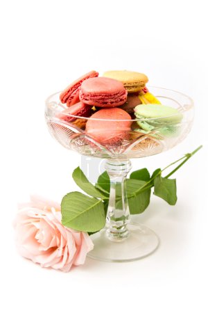 Colorful macaroons and rose on white background