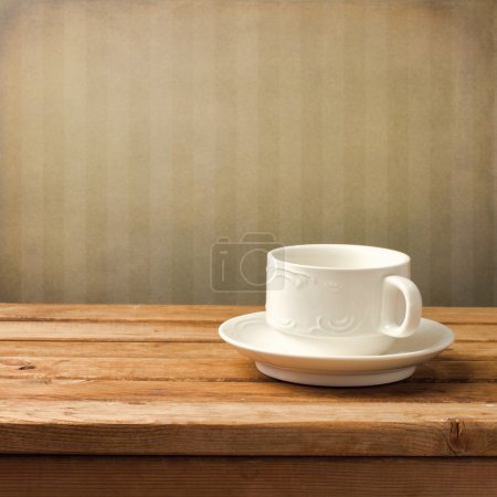Beautiful white coffee cup over vintage background