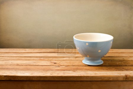 Empty blue bowl on wooden table