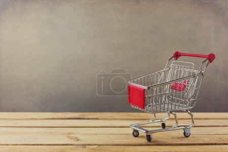 Shopping cart on wooden surface