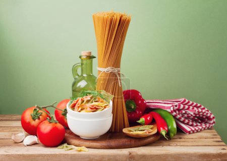 Still life with whole wheat pasta on wooden table