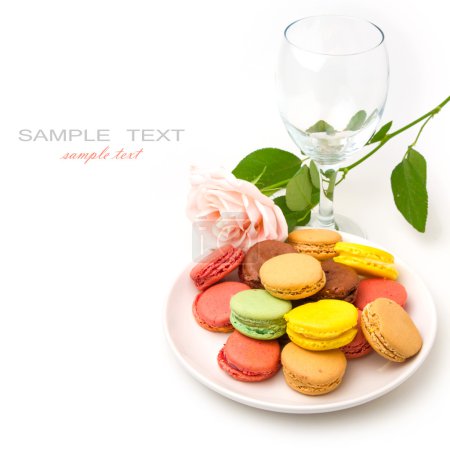 Colorful macaroons and rose on white background