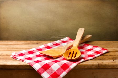 Kitchen utensils on tablecloth on wooden table