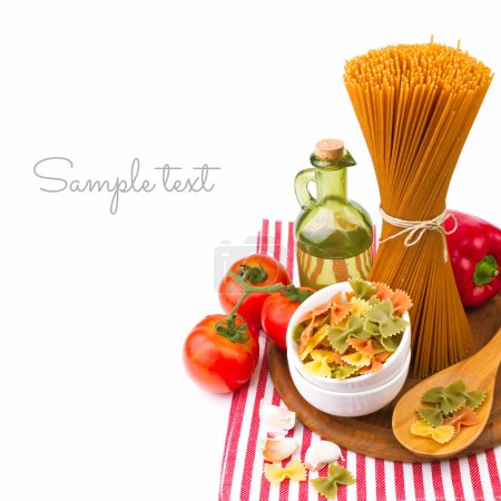 Italian pasta with vegetables on striped tablecloth