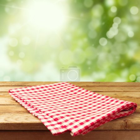Empty wooden deck table with tablecloth