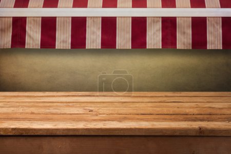 Wooden table with awning background