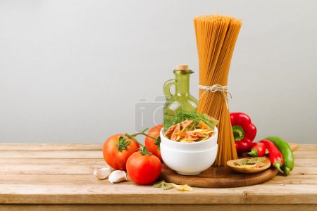 Italian pasta and vegetables on wooden table