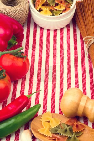 Background with striped tablecloth and raw food